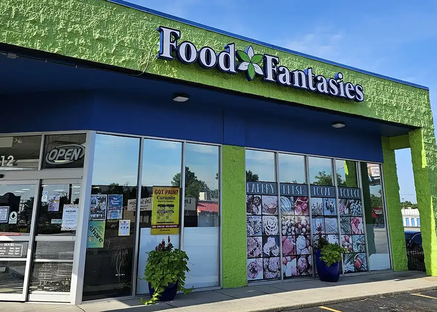 Food Fantasies natural grocery entrance, lime green walls, and flower planters in Springfield, IL