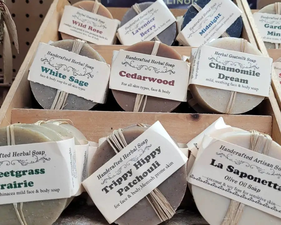 Stacked rounds of handmade artisan soap with scents like patchouli, wild rose, and lavender berry at Food Fantasies near Sherman, IL